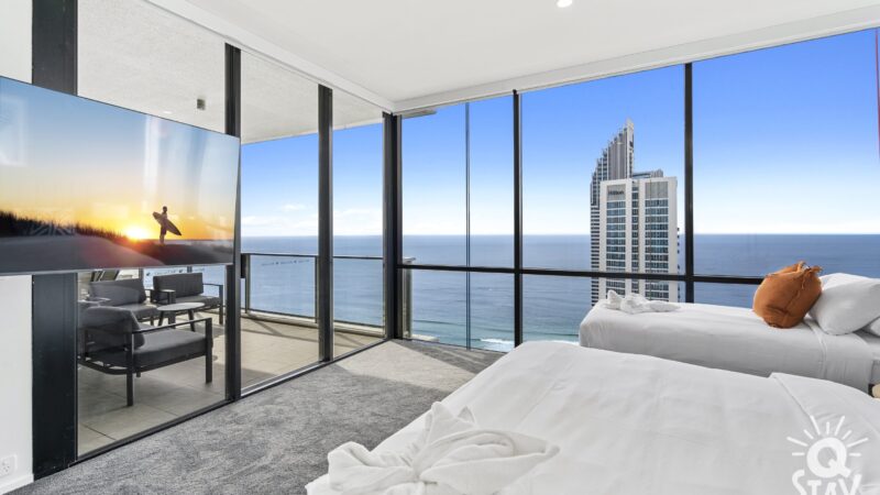 Master bedroom with floor to ceiling windows looking to the ocean